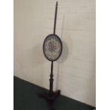 A Regency Rosewood Pole Screen with Oval Adjustable Tapestry on Triform Base.
