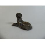 An Oriental Bronze Scroll Weight in the Form of a Reclining Dragon. 7cm long.