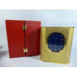 A Cased Patek Philippe Solar Powered Gilt Brass Cased Mantel Clock of Oval Form. No 1.802.