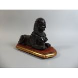 A 19th Century Bronzed Spelter Sphinx Supported on a Giltwood Plinth. 26cm Wide.