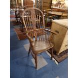 A Hooped Back Elm Seated Windsor Armchair, One Spindle Broken.