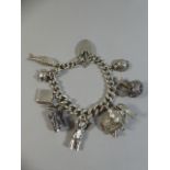 A Good Heavy Silver Charm Bracelet with Eight Various Charms, to Include Articulated Teddy Bear,