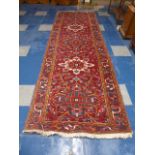 A Patterned Persian Runner on Red Ground