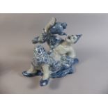 An Oriental Blue and White Ceramic Study of Reclining Gent Drinking Tea Directly from a Teapot.