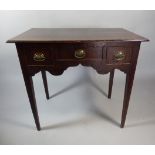 A 19th Century Oak Low Boy with Centre Drawer Flanked by Deeper Drawers having Oval Brass Handles,