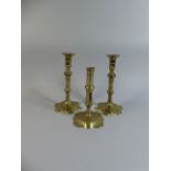 A Pair of Victorian Brass Candlesticks together with One Other having External Pusher. 21 and 17.