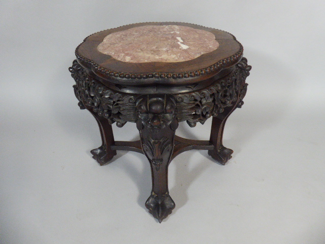 A Richly Carved and Pierced Oriental Hardwood Vase Stand with Inset Marble Top on Claw Feet.