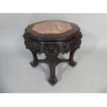A Richly Carved and Pierced Oriental Hardwood Vase Stand with Inset Marble Top on Claw Feet.