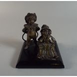 A Victorian Figural Brass Desk Top Paper Weight Depicting Boy with Hoop and Seated Girl,