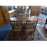 A Modern Oak Refectory Style Dining Table and Four Spindle Back Chairs