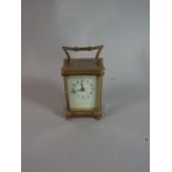 A French Brass Carriage Clock with White Enamel Dial and Blue Arabic Numbers,