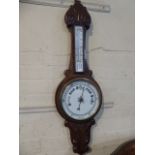 A Late Victorian Oak Onion Topped Wheel Barometer with White Enamel Dial and Temperature Scale,