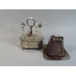 A Silver Plate and Glass Seven Bottle Oval Cruet Set and Stainless Steel Bread Toaster