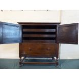 An Edwardian Oak Bedroom Cabinet with Panelled Doors to Three Slides and Base Drawer Under,