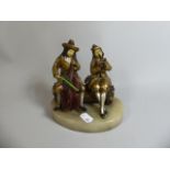 A Cold Painted Continental Figure Group of Two Musicians Sat on Log, Set on Oval Alabaster Base,