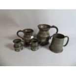 A Collection of Four Pewter Measures and a Tankard