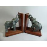 A Pair of Edwardian Carved and Painted Novelty Book Ends in the Form of Elephants,