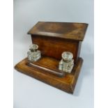 A Late Victorian Two Bottle Desk Top Stationery Box with Two Glass Ink Wells and Pen Rest,