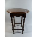 A Small Oak Circular Topped Occasional Table with Bobbin Supports,