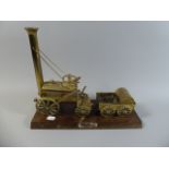 A Brass Model of Stephenson's Rocket Set on Wooden Plinth,