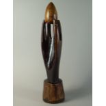 A 19th Century Ethnic Carved Wooden Hand Holding an Egg Between its Fingers, on a Shaped Plinth.