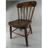 A 19th Century Country Made Child's Chair with Beechwood Spindles and Elm Seat.