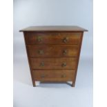 An Early 20th Century Heals Oak Chest of Drawers with a Solid Top Over Four Graduated Drawers with