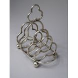 A Silver Toast Rack. The Partitions of Trefoil Form and with Trefoil Carrying Handle to Top.