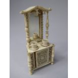 An Unusual Carved Ivory Miniature Mirror Backed Sideboard, Late 19th/Early 20th Century.