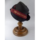 An Early 20th Century Ladies Salvation Army Bonnet, Supported on a Turned Ashwood Stand.
