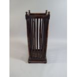 A Late 19th Century Arts and Crafts Oak Umbrella Stand with Slender Turned Spindles.