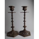 A Pair of 19th Century Continental Bronze Candlesticks with Baroque Decoration.