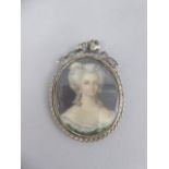 A Continental Oval Miniature 19th Century Lady in Silver Frame with Ribbon and Bow Mount.