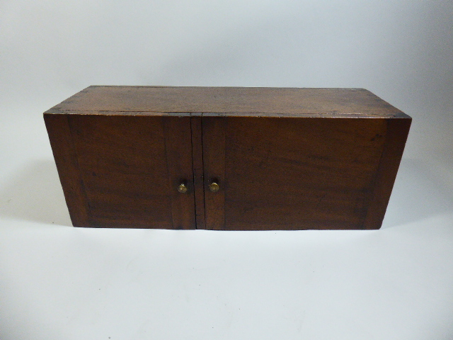 An Early 19th Century Mahogany Campaign Cupboard with two Doors Flanked by Two Brass Carrying