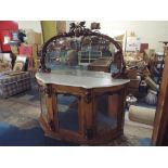 A Victorian Marble Topped Demi Lune Walnut Credenza with Mirrored Doors and Carved Flower and Fruit