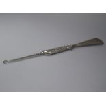 A Silver Handled Button Hook and Shoe Horn, Decorated with Ferns and Leaves in Relief.