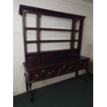 An Early Oak Shropshire Dresser. The Three Fielded Drawers with Brass Handles and Escutcheons.