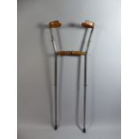 A Pair of Early 20th Century Metal Crutches with Wood and Leather Grips.