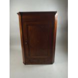 A 19th Century String and Shell Inlaid Corner Cabinet with Panelled Door to Shaped Shelves.