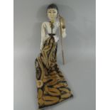 A Vintage Malaysian Wooden Head Puppet in Original Dress and Painted in Polychrome Enamels.