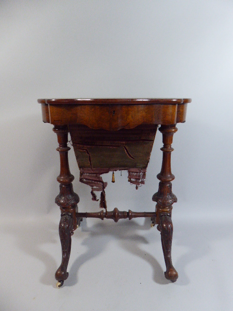 A Pretty Victorian Walnut Ladies Work Table of Shaped Oval Form.