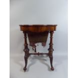 A Pretty Victorian Walnut Ladies Work Table of Shaped Oval Form.