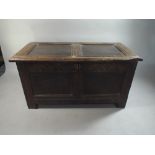 An Early Oak Small Two Panel Coffer Chest with Peg Joints and Carved Front Top Rail.