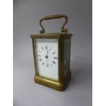 A French Brass Carriage Clock with White Enamel Dial