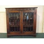 An Oak Leaded Glazed Three Shelved Bookcase, With Carved Top Rail,