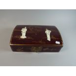 A Lacquered Japanese Dome Topped Box with Brass Clasp, Decorated in Relief with two Maidens,