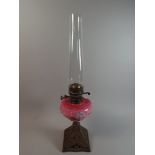 A Victorian Brass Based Oil Lamp with Coloured Opaque Glass Reservoir and Duplex Controls