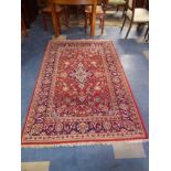 A Persian Kashan Rug on Red Ground,