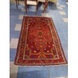An Antique Persian Behbahan Rug on Red Ground 181x115cm