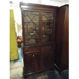 An Astragal Glazed Mahogany Bookcase with Two Centre Drawers and Cupboard Base,